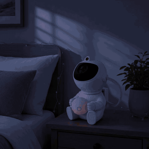 GIF: dark bedroom lights up as Astro switches on and fills the wall with a nebula